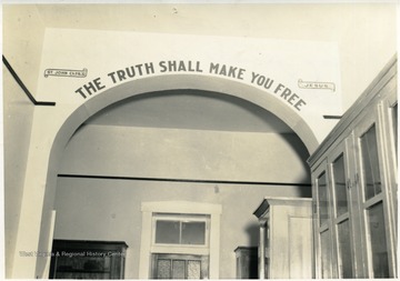 Above the entrance is written, 'The truth shall make you free. St. John, Ch. 8, Vs. 32; Jesus.'