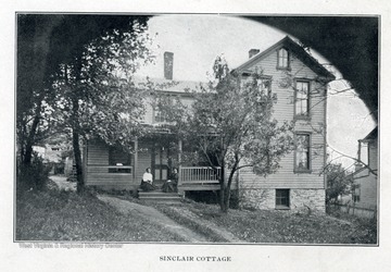 Two African-American ladies seated on the porch of Sinclair Cottage.