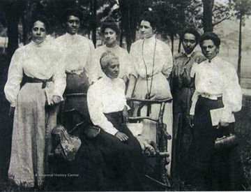 Women of the Niagara Movement at Storer College in Harpers Ferry, W. Va.  Left to right are Mrs. O. M. Waller, Mrs. H. F. M. Murray, Mrs. Mollie Lewis Kelan, Mrs. IdaD. Bailey, Miss Sadie Shorter, and Mrs. Charlotte Hershaw.  Mrs. Gertrude Wright Morgan is seated.