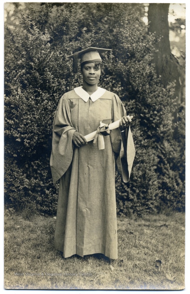 Graduation portrait of African-American student Bernell Bows in cap and gown holding her diploma.  Bows graduated from Storer in 1933.